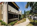 Low angle view of the condo showcasing the building's architecture and landscaping at 2571 Cyprus Dr # 1-105, Palm Harbor, FL 34684