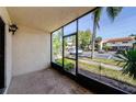 Enclosed porch with concrete flooring and view of lush landscaping at 2571 Cyprus Dr # 1-105, Palm Harbor, FL 34684