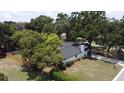 Aerial view of a beautiful home with a spacious yard and lush landscaping at 2715 Willow Oaks Dr, Valrico, FL 33594