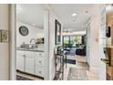 Inviting entryway with light wood floors, modern decor, and view of the living room at 36750 Us 19 N # 17106, Palm Harbor, FL 34684