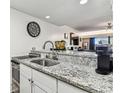Kitchen view of the breakfast bar area that overlooks the bright and open living room at 36750 Us 19 N # 17106, Palm Harbor, FL 34684