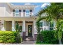 Inviting front entrance showcasing a covered porch with decorative columns and lush landscaping at 4117 W Platt St, Tampa, FL 33609