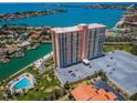 Stunning aerial view of condo building, showcasing its waterfront location, parking, and pool at 4900 Brittany S Dr # 1606, St Petersburg, FL 33715