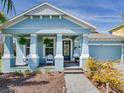Inviting front porch with seating, decorative plants, and charming details that enhance curb appeal at 5128 Admiral Pointe Dr, Apollo Beach, FL 33572