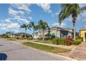A cozy neighborhood with homes featuring lush landscapes and paver driveways at 689 Chipper Dr, Sun City Center, FL 33573