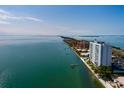 Scenic aerial view of the condominium building along the coast, showcasing water and nearby bridge at 7200 Sunshine Skyway S Ln # 3D, St Petersburg, FL 33711