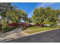 Charming single-story home with a brick paver driveway and vibrant landscaping at 8823 Crescent Forest Blvd, New Port Richey, FL 34654