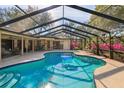 Sparkling screened-in pool with ample deck space for lounging and outdoor enjoyment at 8823 Crescent Forest Blvd, New Port Richey, FL 34654