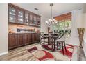Elegant dining room with custom built-ins, stylish lighting, and a cozy seating arrangement at 9302 Deer Creek Dr, Tampa, FL 33647