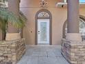 Up close of the white front door entrance and stone column accents at 9711 Wydella St, Riverview, FL 33569