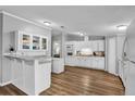 Bright kitchen offers white cabinetry, modern appliances, and sleek countertops at 10404 Hawk Ct, Riverview, FL 33578