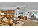 Spacious living room featuring a brick fireplace and comfortable seating at 10404 Hawk Ct, Riverview, FL 33578