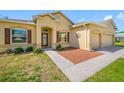 Inviting home exterior with a well-kept lawn and brown-trimmed windows, offering a warm and appealing curb presence at 12442 Curry Dr, Spring Hill, FL 34609