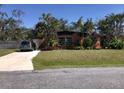 Charming single-story home with a well-manicured lawn, mature trees and a private driveway at 1465 Fundy Rd, Venice, FL 34293