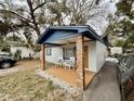 Charming single story home featuring a cozy porch with rocking chairs and blue accents at 1731 W Perio St, Tampa, FL 33612