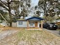 Charming single story home featuring a cozy porch with rocking chairs and blue accents at 1731 W Perio St, Tampa, FL 33612