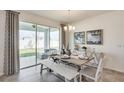 Cozy dining area with sliding glass doors to the patio and a stylish chandelier at 19672 Gladeview Way, Land O Lakes, FL 34638