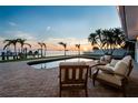 Waterfront property with a private pool, patio, and dock overlooking stunning sunset views at 200 Driftwood W Dr, Palm Harbor, FL 34683