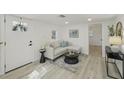 Bright living room featuring neutral furniture, modern decor, and a stylish area rug at 2111 E Ellicott St, Tampa, FL 33610