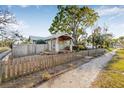 Charming home featuring a well-manicured lawn, delightful front porch, and a quaint wooden fence at 3000 2Nd N Ave, St Petersburg, FL 33713