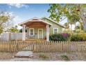 Charming home featuring a well-manicured lawn, delightful front porch, and a quaint wooden fence at 3000 2Nd N Ave, St Petersburg, FL 33713