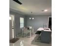 Comfortable dining area featuring a glass table, modern chairs, and a stylish ceiling fan at 3106 W Dewey, Tampa, FL 33607