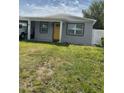Charming single-story home with a bright yellow door, cozy carport, and well-kept lawn at 3106 W Dewey, Tampa, FL 33607