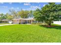 Landscaped front yard featuring mature trees and bushes add beauty and shade to the property at 3952 Applegate Cir, Brandon, FL 33511