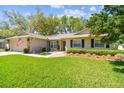 Charming home with a well-maintained lawn, mature landscaping, and an attached two-car garage at 3952 Applegate Cir, Brandon, FL 33511