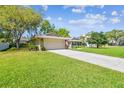 View of the front yard and front of the home with an attached garage and long driveway at 3952 Applegate Cir, Brandon, FL 33511