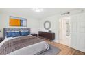 Comfortable bedroom with a soft bed, stylish decor, wood floors, and ample natural light at 4229 Redcliff Pl, New Port Richey, FL 34652