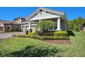 Lovely home with a well-manicured lawn, elegant landscaping, and a side-entry three car garage at 4782 Night Star Trl, Odessa, FL 33556