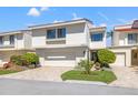 Charming two-story home with a well-manicured front yard, brick paved driveway and a two-car garage at 5625 Escondida S Blvd, St Petersburg, FL 33715
