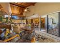 Inviting living room featuring a soaring wood ceiling, comfortable seating, and seamless flow to the dining area at 5625 Escondida S Blvd, St Petersburg, FL 33715