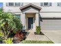 This home has a covered front door, two-car garage, and lush front yard landscaping at 6236 Dutton Dr, Wesley Chapel, FL 33545