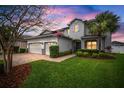 Charming two-story home features a two-car garage and a well-manicured lawn and landscaping at 8141 Carlton Ridge Dr, Land O Lakes, FL 34638