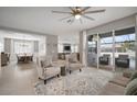Open-concept living room with tile floors and lots of natural light from sliding glass doors at 8141 Carlton Ridge Dr, Land O Lakes, FL 34638
