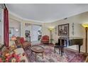 Traditional living room featuring elegant furniture, a piano, and large windows, perfect for entertaining and relaxation at 9314 Heritage Oak Ct, Tampa, FL 33647