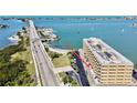 Waterfront condo building with mature landscaping, street view and beach access at 100 Bluff View Dr # 117C, Belleair Bluffs, FL 33770