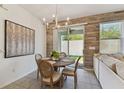 Dining area featuring a round table, stylish chairs, and sliding glass doors to the outdoor space at 1018 Rose Blossom Ct, Tampa, FL 33613