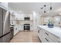 Bright kitchen featuring stainless steel appliances, white cabinets, quartz countertops, and modern fixtures at 1104 S Lois Ave, Tampa, FL 33629