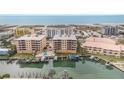 A high-angle shot shows residences, a pool and boat docks with ocean and beach in background at 11525 Gulf Blvd # 401, Treasure Island, FL 33706