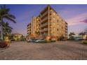 Stately condo building boasts multi-level balconies, brick-paved parking and tropical landscaping at 11525 Gulf Blvd # 401, Treasure Island, FL 33706