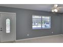 Living room with neutral paint, a bright window, and a view of the outside at 124 Gloucester Blvd # 355J, Sun City Center, FL 33573