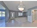 Bright living room with tile flooring, ceiling fan, and a decorative chandelier at 124 Gloucester Blvd # 355J, Sun City Center, FL 33573