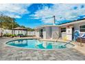 Backyard featuring a refreshing pool, cozy gazebo, and a well-maintained patio for outdoor enjoyment at 1247 Holiday Dr, Tarpon Springs, FL 34689