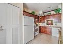 Bright kitchen with wood cabinetry, granite countertops, and modern appliances at 1333 Shady Pine Way # B, Tarpon Springs, FL 34688