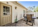 Inviting outdoor patio area with table and chairs, perfect for relaxation and enjoying the weather at 1333 Shady Pine Way # B, Tarpon Springs, FL 34688