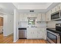 Kitchen with stainless steel appliances and white cabinetry at 1375 Doolittle Ln # 101, Dunedin, FL 34698