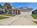 Inviting single-Gathering home showcasing manicured landscaping, walkway, and attached garage at 14885 Caravan Ave, Odessa, FL 33556